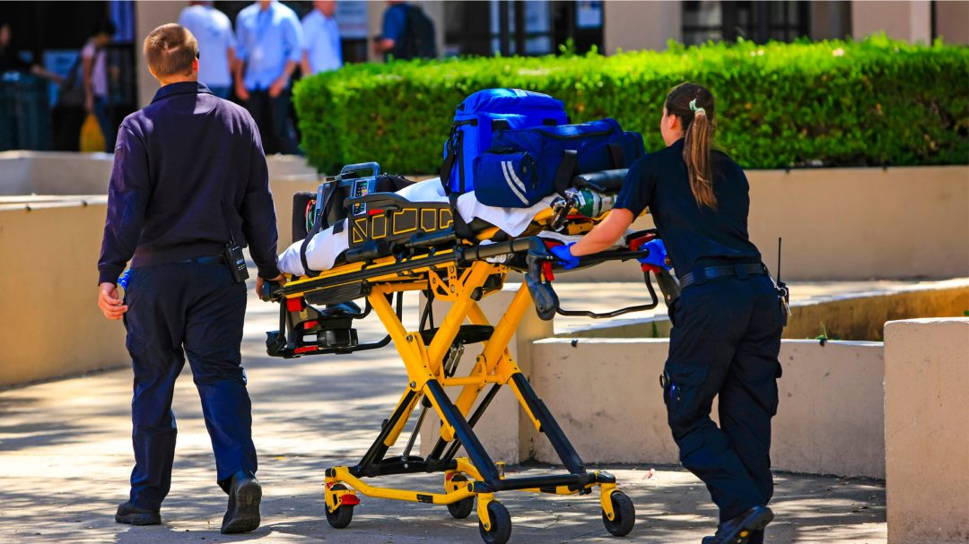 Paramedics pushing a gurney loaded with life saving equipment